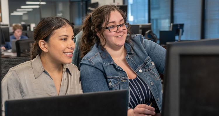 A photo of two R2 Logistics' employees working for the 2026 Top 10 3PL Excellence Awards article.